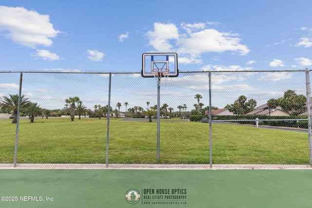 view of sport court featuring a lawn