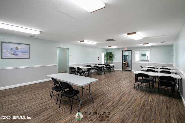 dining area with dark wood-type flooring