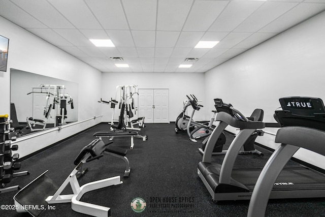 exercise room featuring a paneled ceiling