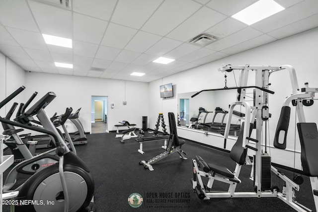 exercise room featuring a paneled ceiling