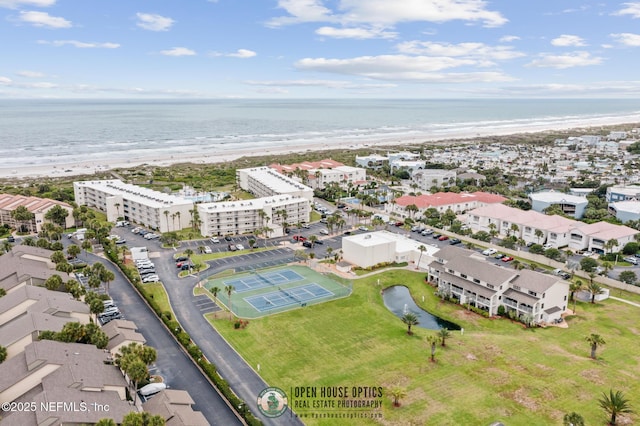 aerial view with a water view and a beach view