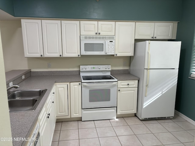 kitchen with white cabinetry, sink, white appliances, and light tile patterned floors