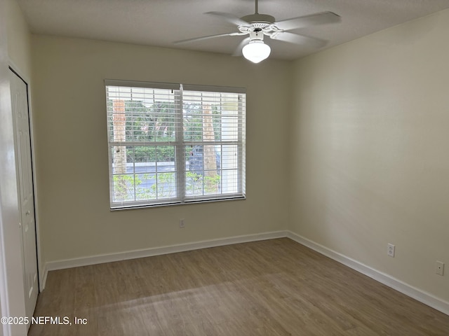 spare room with hardwood / wood-style flooring and ceiling fan