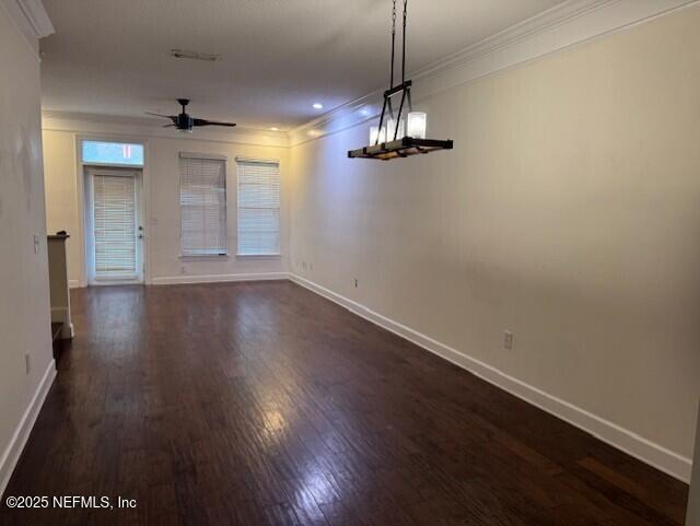 unfurnished dining area with crown molding, dark hardwood / wood-style floors, and ceiling fan