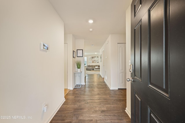 hallway with dark hardwood / wood-style floors