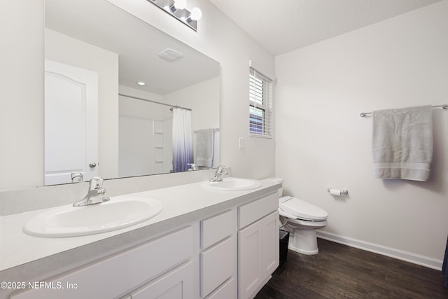 bathroom featuring a shower with curtain, wood-type flooring, toilet, and vanity