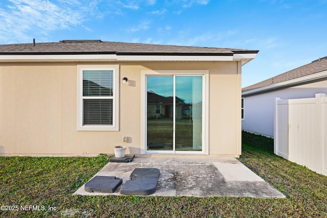 rear view of house with a lawn and a patio area