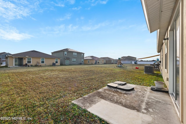 view of yard featuring cooling unit, a patio area, and a playground