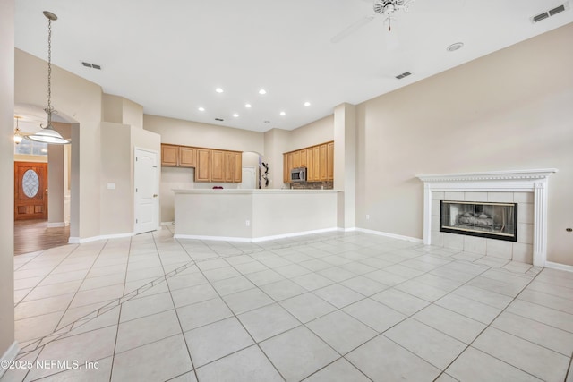 unfurnished living room featuring visible vents and baseboards