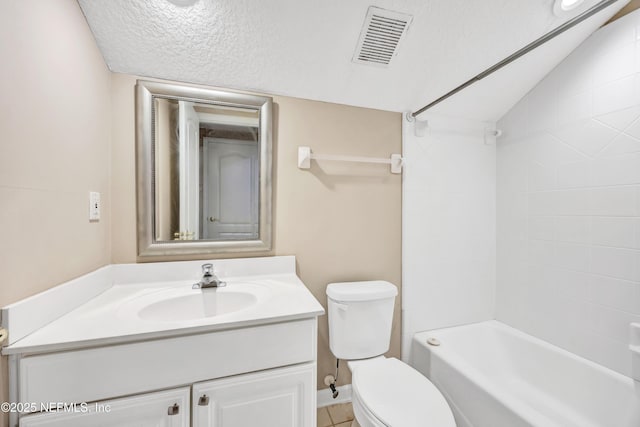 bathroom featuring toilet, visible vents, a textured ceiling, and vanity