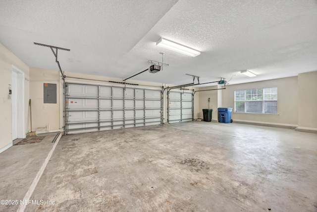 garage with electric panel, baseboards, and a garage door opener