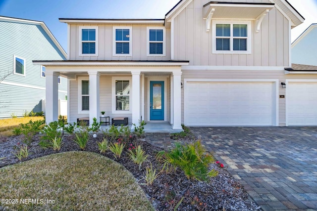 view of front facade featuring a porch and a garage