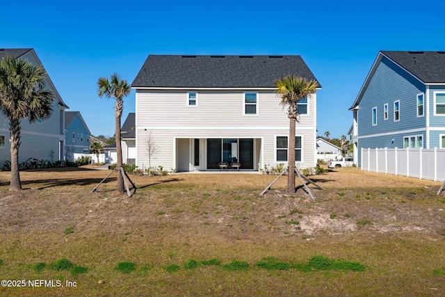 rear view of house with a lawn and a patio