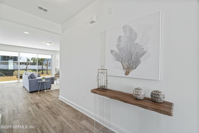 hall with light hardwood / wood-style floors