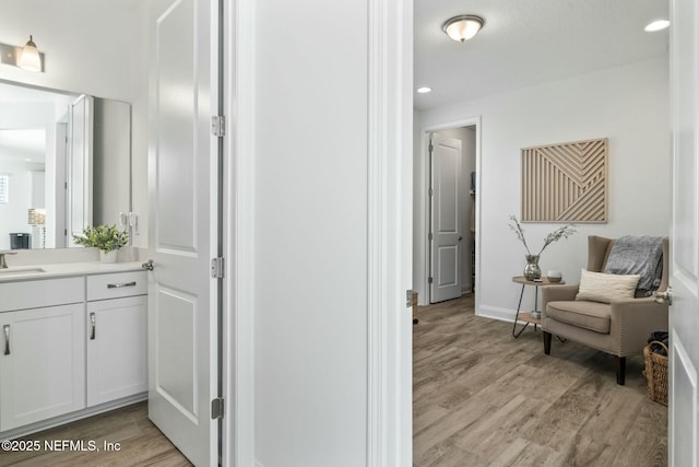 interior space with vanity and hardwood / wood-style floors