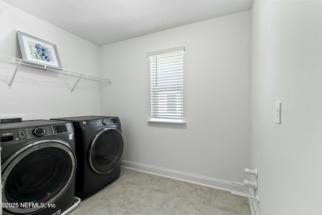 clothes washing area with washer and dryer