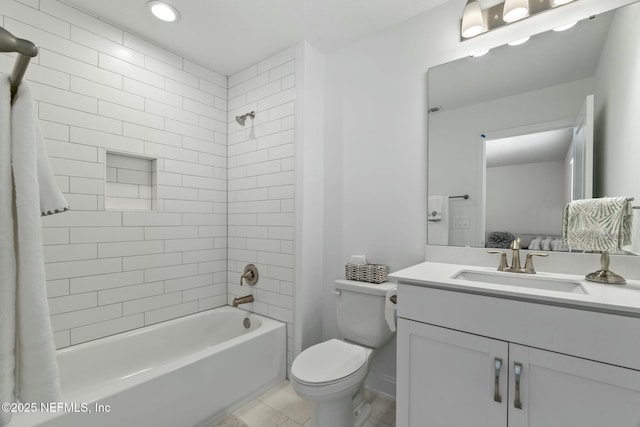 full bathroom with vanity, tiled shower / bath combo, and toilet