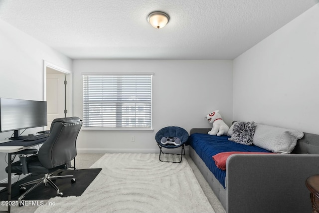 bedroom featuring light carpet and a textured ceiling