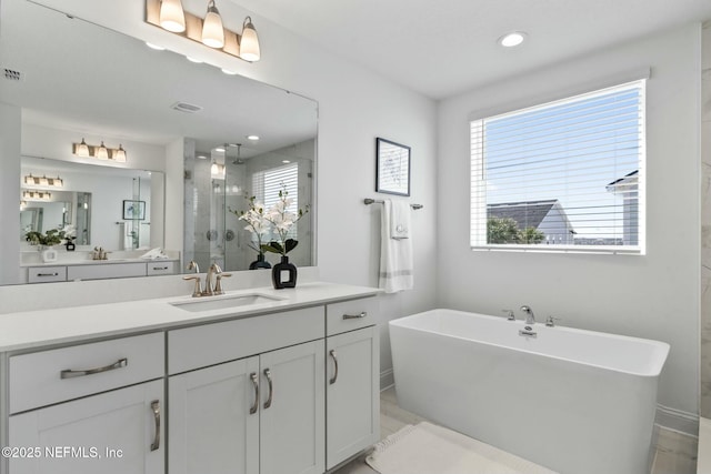 bathroom featuring vanity and separate shower and tub