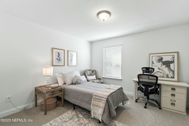 bedroom featuring carpet and a textured ceiling