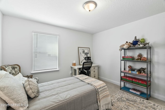 carpeted bedroom featuring a textured ceiling