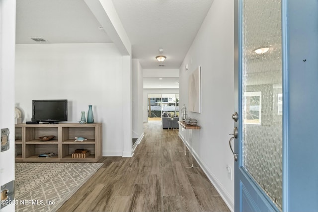 hall with hardwood / wood-style floors