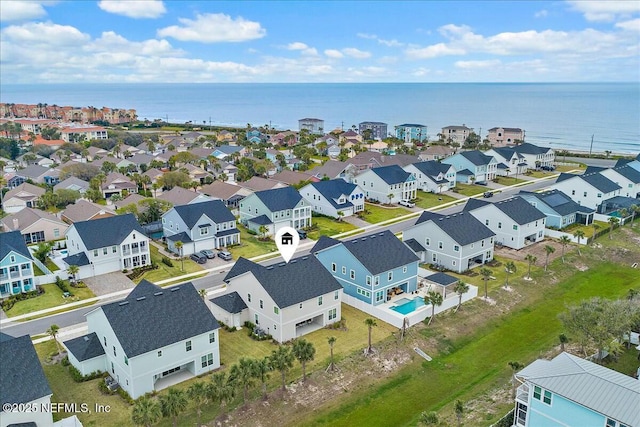 drone / aerial view with a water view and a residential view