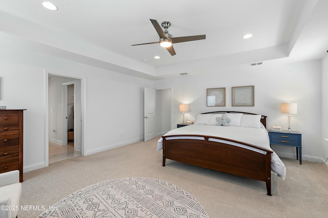 bedroom featuring a tray ceiling, recessed lighting, and visible vents