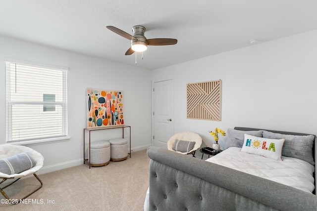 bedroom with baseboards, ceiling fan, and light colored carpet