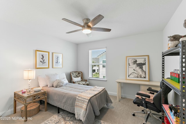 carpeted bedroom featuring ceiling fan and baseboards
