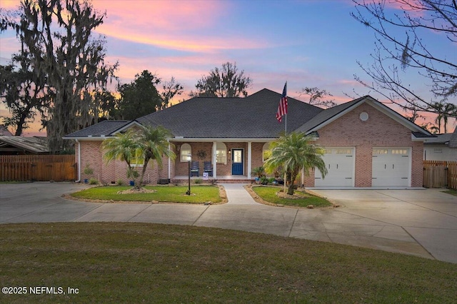 ranch-style home with a yard and a garage