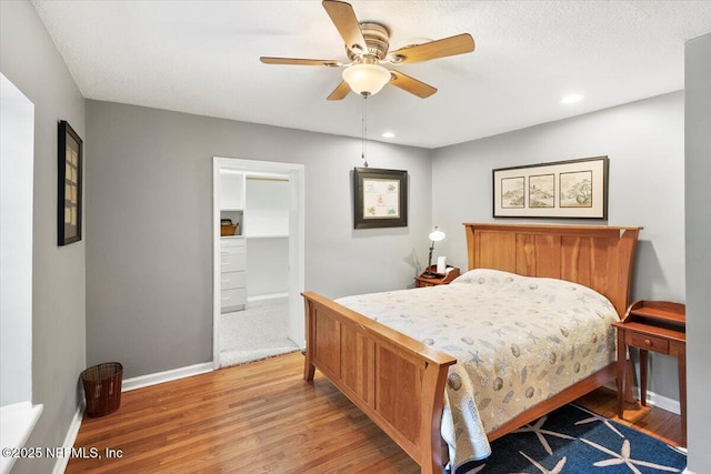 bedroom featuring hardwood / wood-style flooring and ceiling fan