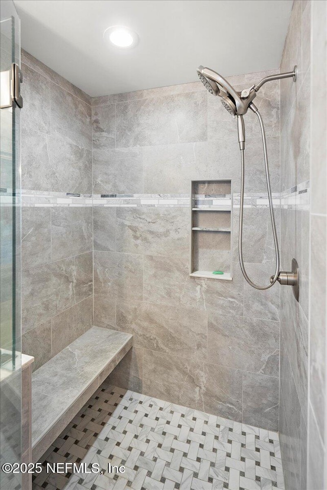 bathroom featuring tiled shower