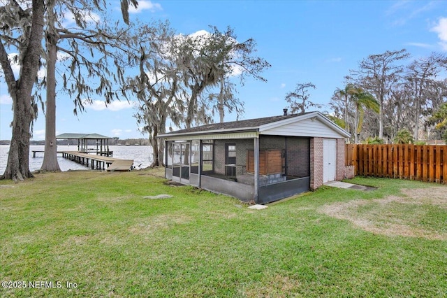 back of house featuring a water view and a yard