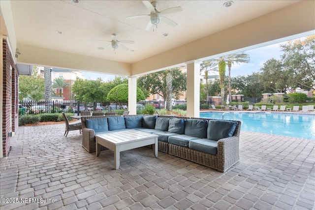 view of patio / terrace with a community pool, outdoor lounge area, and ceiling fan