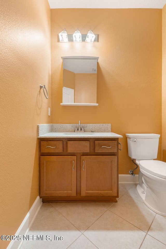 bathroom with vanity, tile patterned floors, and toilet