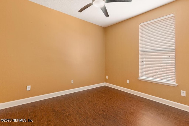 spare room featuring hardwood / wood-style floors and ceiling fan