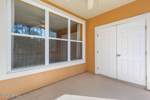 interior space with ceiling fan