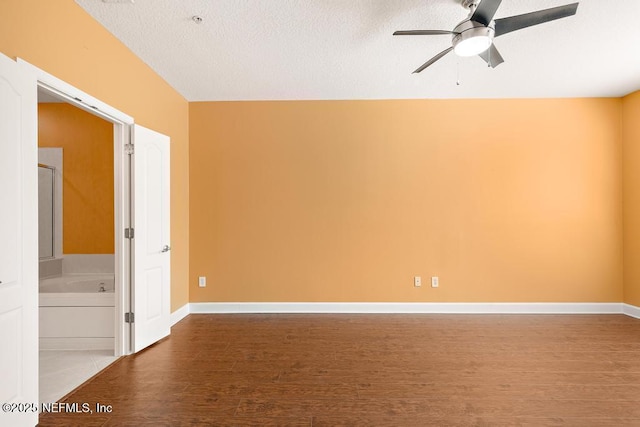 empty room featuring ceiling fan, wood-type flooring, and a textured ceiling