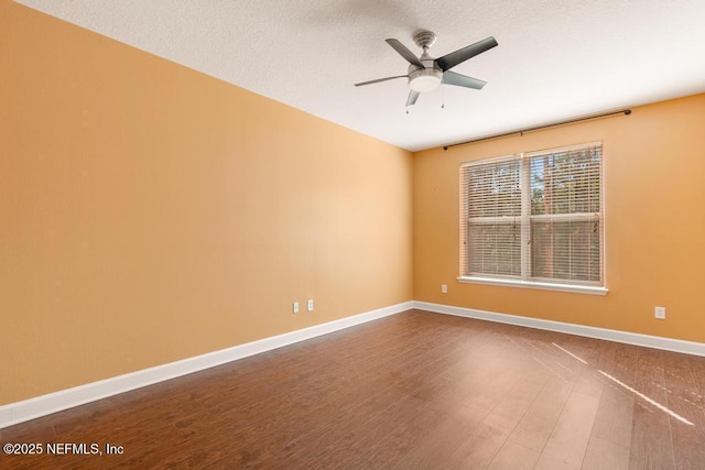 empty room featuring hardwood / wood-style flooring and ceiling fan