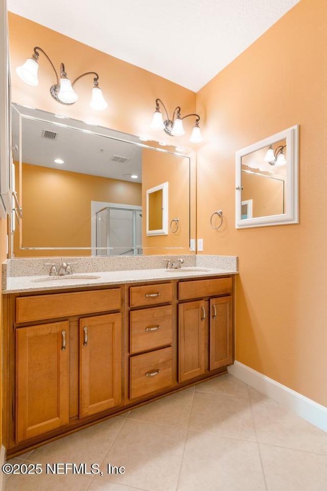 bathroom featuring tile patterned floors, vanity, and an enclosed shower