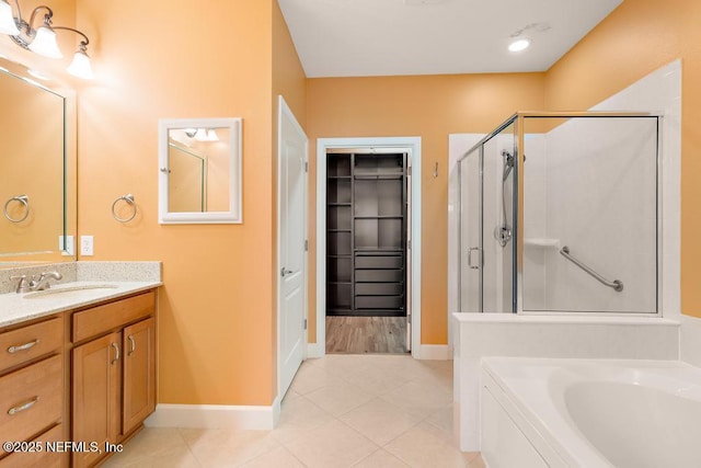 bathroom featuring tile patterned floors, vanity, and separate shower and tub