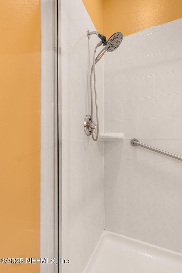 bathroom with a tile shower