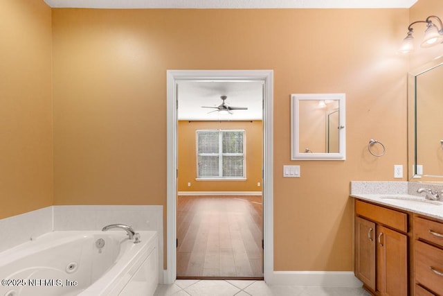 bathroom featuring ceiling fan, vanity, tile patterned flooring, and a bathtub