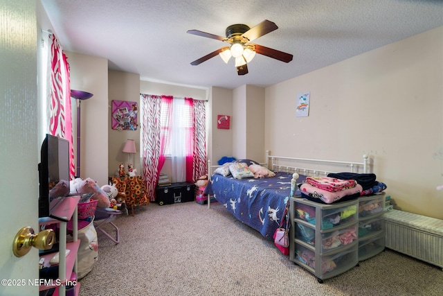 carpeted bedroom with a textured ceiling and ceiling fan