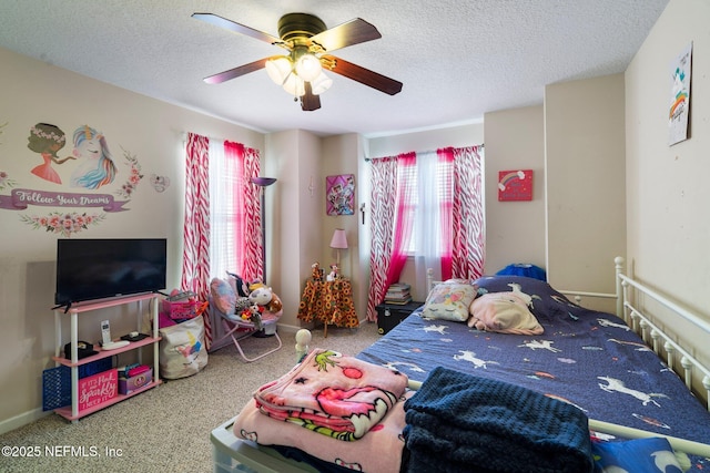 carpeted bedroom with multiple windows, a textured ceiling, and ceiling fan