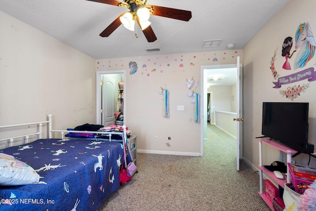 bedroom featuring ceiling fan, carpet floors, and a textured ceiling