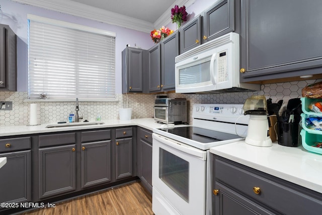 kitchen with crown molding, sink, backsplash, and white appliances