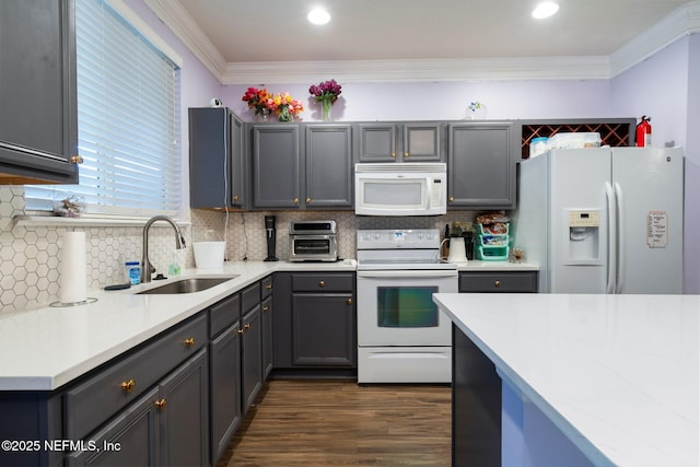 kitchen featuring sink, gray cabinetry, crown molding, white appliances, and backsplash