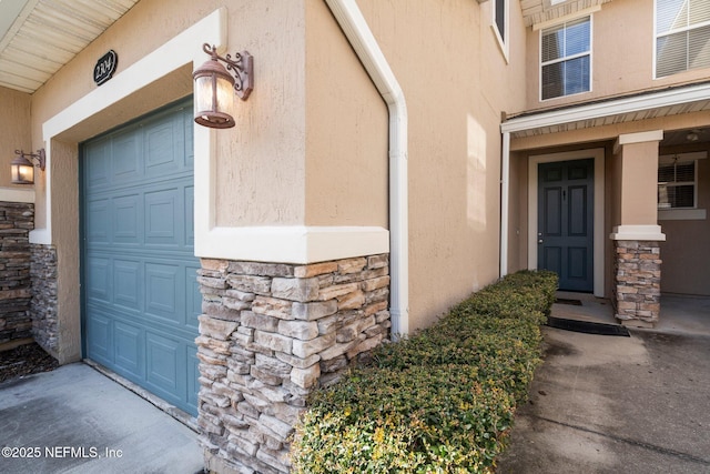 view of exterior entry with a garage